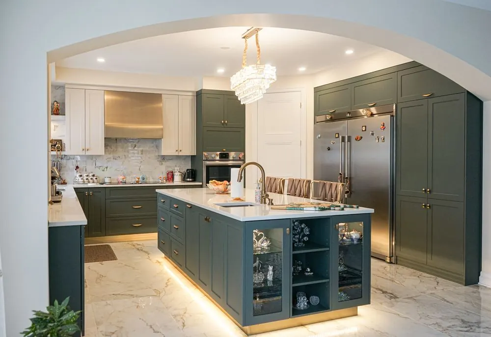Traditional green kitchen with a glass fronted island and a chandelier